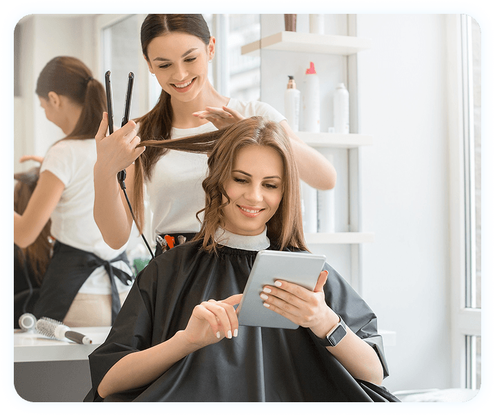 Woman on laptop in salon
